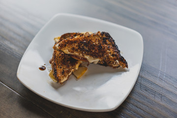 gourmet grilled cheese sandwich on white plate