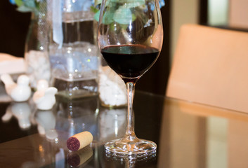 glass of red wine over the table with decoration