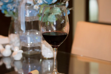 glass of red wine over the table with decoration