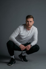 Portrait of beautiful man on grey background. Studio Isolated