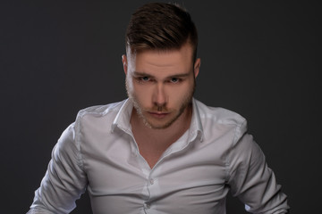 Fototapeta premium Portrait of beautiful man on grey background. Studio Isolated