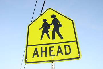 pedestrian crossing sign on blue sky