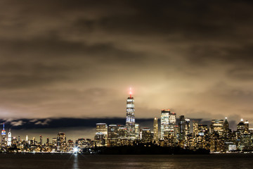 Fog rolling across New York City night time skyline 