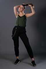 Portrait of girl posing in studio on grey background. Isolated