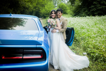 The bride and groom in a beautiful respectable wedding car.