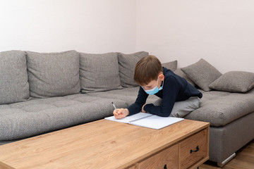 Isolated child Quarantined at Home in mask, Coronavirus Epidemic. Distance education and learning. Self isolation, home quarantine. World Crisis COVID-19. Distance learning at home. Space for text
