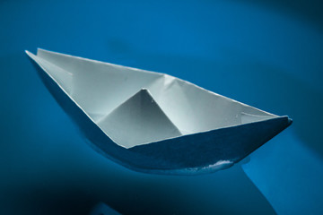 Paper boat in the blue sea