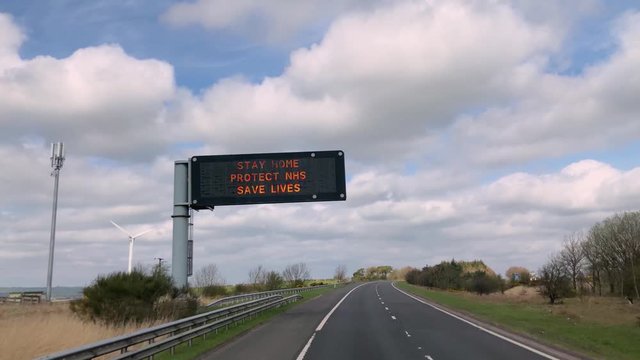 An electronic road sign with information about the coronavirus, slow motion, 4K