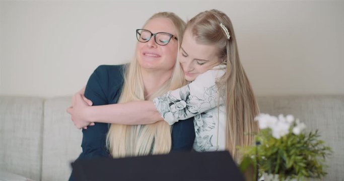 Two Happy Sisters Hugging Together and Giving Support to Each Other Smiling Into Camera