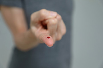 Close up of finger that has been pricked for a blood test