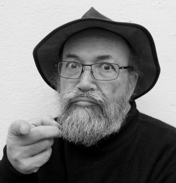 Portrait Of Angry Man Pointing Against White Background