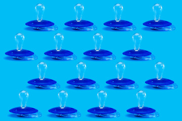 pacifier pattern plastic soother isolated on blue background with clones objects.