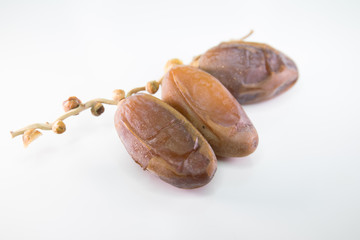 Dried dates on white background