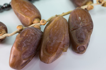 Dried Dates with rosemary beads in white background
