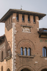 Renaissance brick tower with triple lancet window in Italy.
