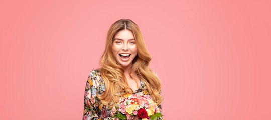 Smiling woman with flowers in hand