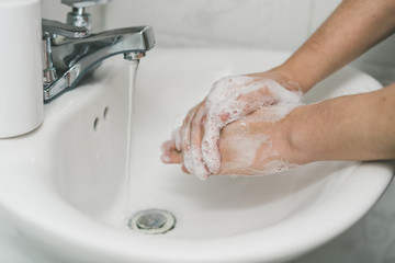 man washing  his hands for coronavirus prevention, hygiene to stop spreading coronavirus.