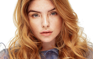 Ginger young woman with natural freckles.