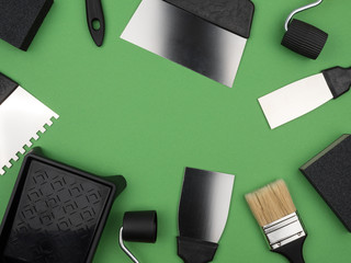 Black tool on a green background. Paint tool.