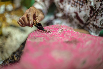 Closeup Hand Painting Batik on the Fabric. Batik Tulis Indonesia