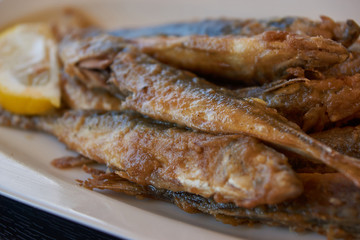 Fried smelt on a plate. Fish dish in a cafe. Seaside lunch