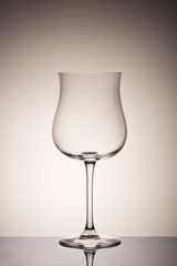 Empty glass for wine on gray background. Wineglass