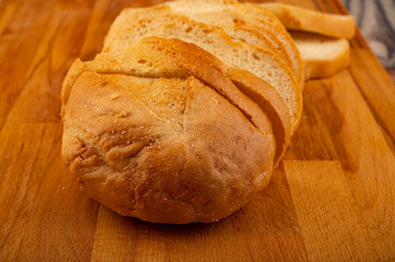 Sliced loaf of wheat bread on a wooden cutting Board. Close up.