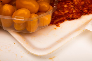 Slices of sausage and bacon and tomatoes on a white background. Close up.