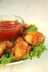 Close up of buffalo wings with barbecue sauce and lettuce