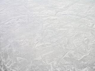 ice skating rink with flacks of ice and ice skating blade marks