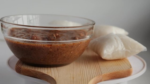 Rotating footage of "kuah kacang" or peanut sauce with "nasi impit". A malay traditional usually serve during Eidul Fitr.