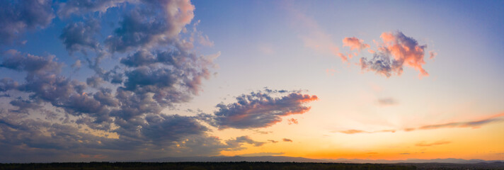 Panorama of sky. Orange blue and violet color sunset sky background