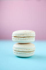 White macarons on pink and blue background