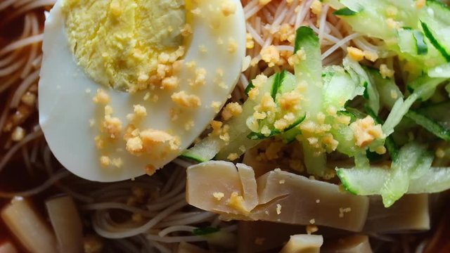 A shallow depth of field footage of "mee belacan" on turntable. Traditional noodle with the shrimp paste sauce 