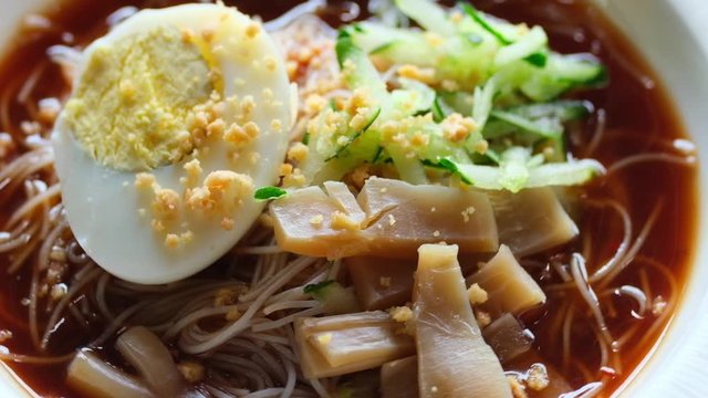A shallow depth of field footage of "mee belacan" on turntable. Traditional noodle with the shrimp paste sauce 
