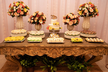 Wedding Setup. Cake table with sweet, decoration and flowers