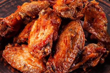 grilled chicken wings in red sauce closeup
