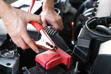 Car maintenance technician He is checking the auto engine, car inspection center.