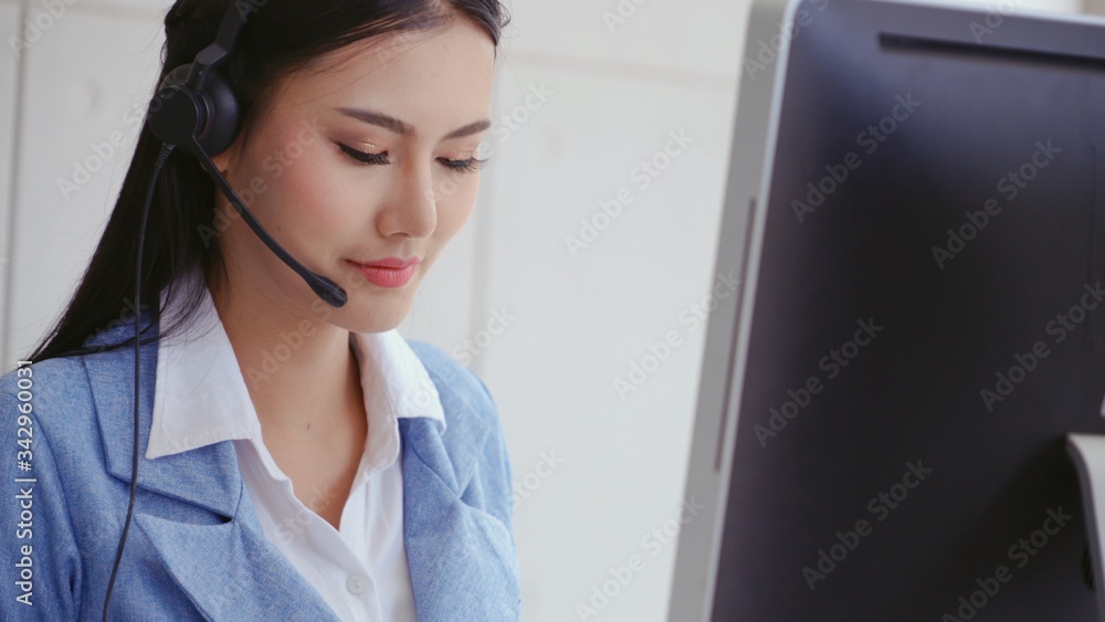 Aufkleber customer support agent or call center with headset works on desktop computer while supporting the cu