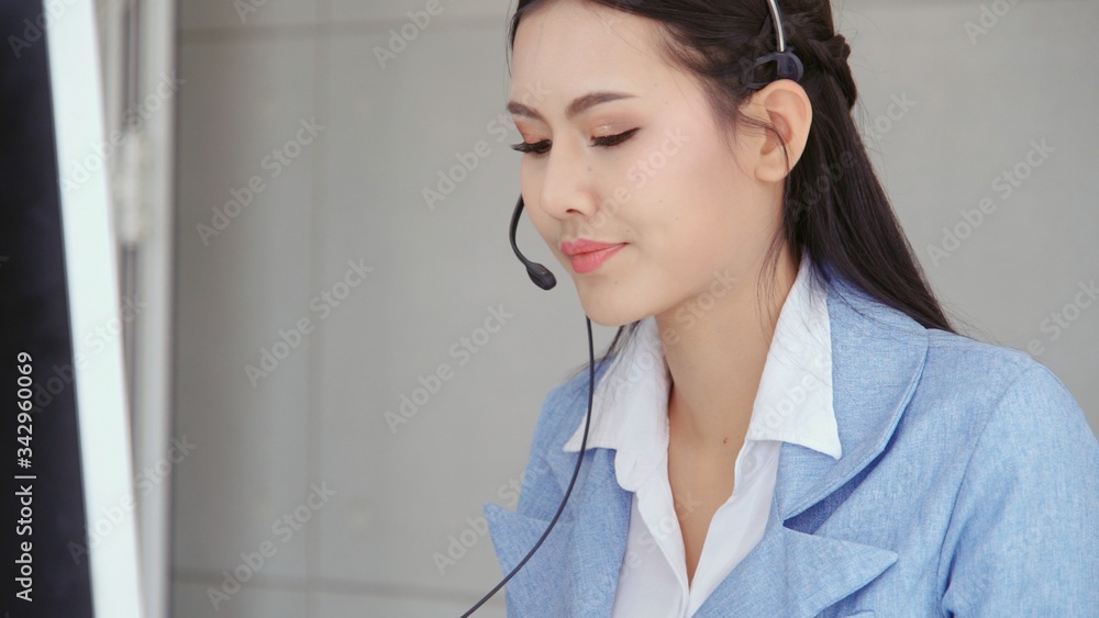 Aufkleber customer support agent or call center with headset works on desktop computer while supporting the cu