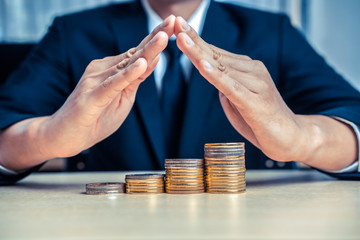 Businessman working with coin money currency. Concept of investment growth and money saving.