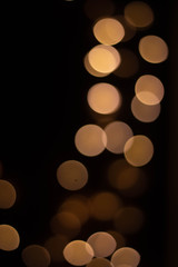 Golden christmas background with bokeh lights.