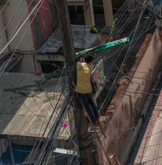 Electrician lineman repairman worker at climbing work on electric post power pole and change transformer.Selective focus