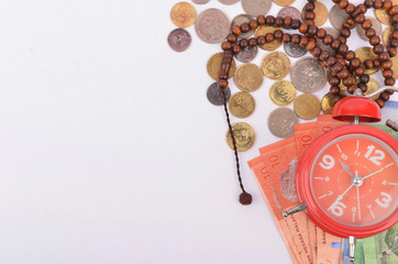 Rosary, banknotes and coins, islamic banking/finance concept.