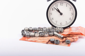 Rosary, banknotes and coins, islamic banking/ finance concept. 