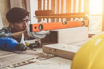 Carpenter working on wood craft at workshop to produce construction material or wooden furniture....