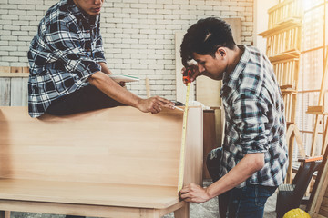 Carpenter working on wood craft at workshop to produce construction material or wooden furniture....