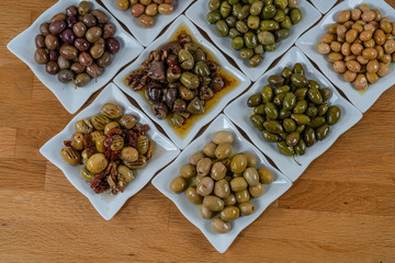 Olives assortment in bowl with oil. 