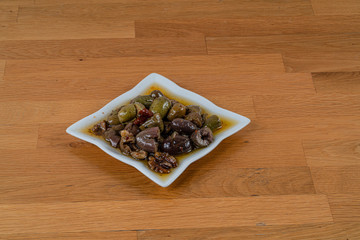 Olives assortment in bowl with oil. 