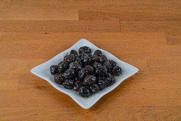 Olives assortment in bowl with oil. 